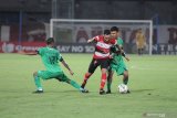 Pesepak bola Madura United (MU) Diego Assis (tengah) berusaha melewati pesepak bola Bhayangkara Fc Nur Iskandar (kiri) dan TM  Ichsan (kanan) dalam laga Shopee Liga 1 di Stadion Gelora Bangkalan (SGB) Bangkalan, Jawa Timur, Jumat (22/11/2019). Bhayangkara FC memenangi pertandingan tersebut dengan skor 2-1. Antara Jatim/Saiful Bahri/zk.