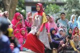 Model memperagakan busana berbahan kain tenun ikat khas Kediri pada Dhoho Street Fashion di Taman Hutan Joyoboyo, Kota Kediri, Jawa Timur, Kamis (5/12/2019). Peragaan busana dengan tema Pride of Jayabaya tersebut menghadirkan sejumlah desainer lokal dan nasional. Antara Jatim/Prasetia Fauzani/zk.