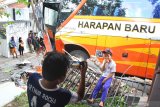 Seorang anak memotret rekannya di depan bangkai bus Harapan Baru jurusan Banyuwangi-Trenggalek bernopol AG 7134 UY yang terlibat kecelakaan beruntun di jalan Teluk Mandar, Malang, Jawa Timur, Senin (9/12/2019). Tidak ada korban jiwa dalam kecelakaan yang melibatkan satu bus, satu mobil angkutan kota dan lima sepeda motor tersebut. Antara Jatim/Ari Bowo Sucipto/zk.