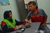 Petugas melakukan pemeriksaan tekanan darah sopir bus di terminal Kepuhsari Jombang, Jawa Timur, Kamis (19/12/2019). Pemeriksaan kesehatan sopir bus meliputi, gula darah, alkohol, tekanan darah dan narkoba itu untuk menjamin keselamatan penumpang angkutan umum jelang libur Natal dan Tahun Baru. Antara Jatim/Syaiful Arif/zk