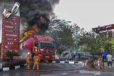 Petugas berusaha memadamkan api pada truk tangki pertamina yang terbakar ketika melakukan pengisian bahan bakar minyak (BBM) di SPBU 3446309 Batulawang, Desa Sukamukti, Kota Banjar, Jawa Barat, Senin (20/1/2020). ANTARA JABAR/Adeng Bustomi/agr