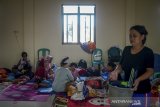 Aktifitas warga yang mengungsi di Kantor Desa Bojongasih, Dayeuhkolot, Kabupaten Bandung, Jawa Barat, Senin (17/2/2020). Sebanyak 47 Kepala Keluarga di Bojongasih mengungsi akibat banjir yang merendam tempat tinggalnya sejak Sabtu (15/2). ANTARA JABAR/Raisan Al Farisi/agr