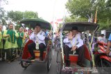 Pasangan perseorangan bakal calon Wali Kota Banjarmasin Anang Misran (kanan) dan wakil Wali Kota Ahmad Firdaus (kiri) menumpang becak saat menuju kantor KPU di Banjarmasin, Kalimantan Selatan, Rabu (19/2/2020). KPU Kota Banjarmasin mulai menerima penyerahan berkas syarat dukungan bakal calon perseorangan pemilihan wali kota dan wakil wali kota Banjarmasin tahun 2020 pada tanggal 19 Februari hingga 23 Februari 2020. Foto Antaranews Kalsel/Bayu Pratama S