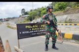 Anggota Pamtas dari Yonif Raider 641/Bru bersiaga di pintu masuk kawasan perbatasan Entikong di Kabupaten Sanggau, Kalimantan Barat, Selasa (25/2/2020). Pasukan pengamanan perbatasan Indonesia-Malaysia dari Yonif Raider 641/Bru memperketat pemeriksaan setiap kendaraan yang masuk ke perbatasan Entikong dari Malaysia guna mengantisipasi penyelundupan narkotika dan senjata api. ANTARA FOTO/Agus Alfian/nym.