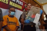 Kapolres Madiun AKBP Eddwi Kurniyanto (kanan) menunjukkan barang bukti penipuan calon Tenaga Kerja Indonesia (TKI) saat merilis kasus tersebut di Mapolres Madiun, Jawa Timur, Kamis (5/3/2020). Polres Madiun menangkap Hariyanto tersangka penipuan calon TKI yang menjanjikan bisa memberangkatkan TKI ke Taiwan dengan korban empat orang dan kerugian uang ratusan juta rupiah. Antara Jatim/Siswowidodo/zk