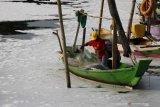 Nelayan beraktivitas di sekitar muara sungai Tambak Wedi yang dipenuhi limbah busa putih di Surabaya, Jawa Timur, Minggu (29/3/2020). Limbah busa putih itu hanyut hingga ke Selat Madura. Antara Jatim/Didik/Zk