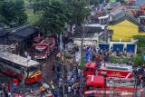 Suasana penanganan kecelakaan tunggal bus karyawan PO Warga Baru yang terbakar di Jalan Raya Cidomba, Telukjambe Timur, Karawang, Jawa Barat, Selasa (14/4/2020). Kecelakaan bus yang membawa karyawan tersebut terbakar setelah menabrak enam kios dan hingga kini penyebab kecelakaan masih dalam penyelidikan pihak berwajib. ANTARA JABAR/M Ibnu Chazar/agr