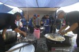 Petugas Taruna Siaga Bencana (Tagana) memasak makanan di dapur umum di kawasan Taman Kamboja, Banjarmasin, Kalimantan Selatan, Rabu (15/4/2020). Dapur umum yang digelar oleh petugas gabungan terdiri dari Tagana, Pemerintah Kota Banjarmasin, TNI dan Polri tersebut untuk membantu menyediakan makanan guna meringankan beban masyarakat berpenghasilan harian akibat terdampak pandemi COVID-19. Foto Antaranews Kalsel/Bayu Pratama S.