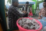 Takmir membagikan takjil hasil pemberian warga kepada jemaah Masjid Agung Asy Syuhadak, Pamekasan, Jawa Timur, Jumat (24/4/2020). Takjil dan nasi tersebut selanjutnya diberikan kepada fakir miskin dan musyafir serta jemaah masjid tersebut Antara Jatim/Saiful Bahri/zk