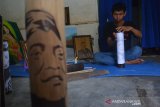 Anang Setyo Pambudi (30) menyelesaikan ukiran pada bambu bergambar wajah almarhum Didi Kempot di Desa Sumberjo, Kabupaten Jombang, Jawa Timur, Rabu (6/5/2020). Ukiran bambu sketsa wajah Didi Kempot yang dibuat seniman tersebut rencananya akan dikirimkan ke pihak keluarga di Ngawi untuk mengenang maestro campursari itu. Antara Jatim/Syaiful Arif/zk