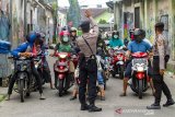 Polisi memberi pemberitahuan penerapan Pembatasan Sosial Berskala Besar (PSBB) kepada pengendara sepeda motor di kawasan Tuparev, Karawang, Jawa Barat, Rabu (6/5/2020). Pemerintah telah resmi memberlakukan penerapan Pembatasan Sosial Berskala Besar (PSBB) di Kabupaten Karawang pada tanggal 6 Mei 2020 selama 14 hari sebagai upaya percepatan penanganan COVID-19. ANTARA JABAR/M Ibnu Chazar/agr