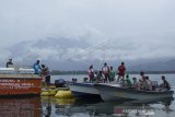 Petugas gabungan bersama masyarakat berada di lokasi pesawat terbang milik maskapai Mission Aviation Fellowship (MAF) yang jatuh di Danau Sentani, Kabupaten Jayapura, Papua, Selasa (12/5/2020). Pesawat perintis dengan nomer penerbangan PK-MEC tujuan Distrik Mamit, Kabupaten Tolikara, Papua jatuh di perairan danau Sentani sekitar pukul 6.29 WIT yang menyebabkan seorang pilot asal Amerika Serikat Joice Lin meninggal dunia. ANTARA FOTO/Gusti Tanati/nym.