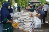 Warga antri berbelanja barang kebutuhan pokok saat berlangsung Pasar Murah Serentak, di Kampung Mulia, Banda Aceh, Aceh, Rabu (13/5/2020). Pemerintah Aceh bekerjasama dengan Perum Bulog menggelar pasar murah serentak di seluruh wilayah Aceh berlangsung hingga 16 Mei 2020 dengan harga subsidi Rp250 hingga Rp3.000 menurut jenis barang itu mewajibkan kepada warga menggunakan masker, cuci tangan dan jaga jarak guna mencegah penyebaran COVID-19. Antara Aceh/Ampelsa.