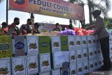 Sejumlah anggota polisi menyiapkan paket bantuan bahan pokok untuk didistribusikan ke warga terdampak pandemi COVID-19 di halaman Mapolres Madiun Kota, Jawa Timur, Jumat (15/5/2020). Dalam kegiatan yang merupakan Gerakan Bakti Sosial Peduli COVID-19 tersebut jajaran Polres Madiun Kota menyalurkan 1.518 paket bahan pokok kepada warga yang membutuhkan guna membantu meringankan beban hidup pada masa pandemi COVID-19 sekaligus menghadapi hari raya Idul Fitri. Antara Jatim/Siswowidodo/zk