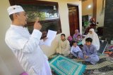 Warga mendengarkan khutbah usai melakukan shalat Idul Fitri 1 Syawal 1441 H di rumahnya, komplek perumahan Cahaya Permata Kota Kediri, Jawa Timur, Minggu (24/5/2020). Sejumlah umat Islam melakukan shalat Id di rumah guna mengurangi interaksi sosial dan menghindari penyebaran COVID-19. Antara Jatim/Prasetia Fauzani/zk.