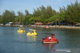 Pengunjung bermain sepeda angsa air di Kolam Wisata Pantai Ulee Lheue, Banda Aceh, Aceh, Rabu (27/5/2020). Sejumlah objek wisata pantai di tengah suasana liburan Idul Fitri di Aceh yang berstatus zona hijau itu menjadi pilihan wisatawan, namun masih sepi pengunjung sejak pandemi COVID-19. Antara Aceh/Ampelsa.