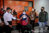 Menko PMK Muhadjir Effendy (kiri) bersama Menteri Sosial Juliari P Batubara (kedua kanan) dan Gubernur Jawa Barat Ridwan Kamil (kanan) berbincang dengan keluarga penerima manfaat saat melakukan kunjungan kerja di Kantor Pos Mandalamukti, Kabupaten Bandung Barat, Jawa Barat, Jumat (29/5/2020). Dalam kunjungan kerja Menko PMK dan Menteri Sosial berkesempatan untuk memberikan langsung bantuan sosial berupa Bantuan Sosial Tunai (BST), Kartu Keluarga Sejahtera serta bantuan pangan non tunai kepada kepada warga terdampak COVID-19 di daerah tersebut. ANTARA JABAR/Raisan Al Farisi/agr