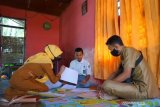 Dua guru SMA Negeri 1 Kabila mengawasi murid yang melakukan ujian akhir semester secara luar jaringan (luring) di rumah Dua guru SMA Negeri 1 Kabila mengawasi murid yang melakukan ujian akhir semester secara luar jaringan (luring) di rumah di Poowo, Kabupaten Bone Bolango, Gorontalo, Selasa (9/6/2020). Sejumlah guru di sekolah tersebut mengantarkan soal ujian ke rumah 51 murid karena tidak memiliki telepon pintar (smartphone) untuk mengikuti ujian dalam jaringan (daring). ANTARA FOTO/Adiwinata Solihin/wsj.