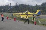 Petugas berada di dekat pesawat dengan nomor penerbangan PK-PAG yang tergelincir di Bandara Karubaga Kabupaten Tolikara, Papua, Selasa (9/6/2020). Pesawat terbang pengangkut BBM bersubsidi yang dioperasikan oleh Pelita Air tersebut tergelincir dan menabrak pagar pembatas landasan pacu saat mendarat, tidak ada korban dalam kecelakaan tersebut. ANTARA FOTO/HO/Humas Polda Papua/nym.