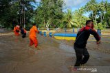 Seorang warga melihat arus deras banjir di Desa Alale, Kabupaten Bone Bolango, Gorontalo, Kamis (11/6/2020). Hujan yang melanda daerah itu sejak hari Rabu (11/6) malam, menyebabkan meluapnya sungai Bone dan bendungan jebol sehingga merendam ratusan rumah warga. (ANTARA FOTO/Adiwinata Solihin)