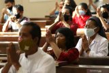 Umat Katolik beribadah misa dengan tetap mengenakan masker di Gereja Katolik Maria Ratu Damai Banyuwangi, Minggu (14/6/2020). Umat Katolik Banyuwangi kembali menggelar misa secara publik di gedung gereja dengan protokol kesehatan yang ketat, setelah 4 bulan misa digelar secara daring di rumah masing-masing karena pandemi COVID-19. Antara Jatim/Budi Candra Setya/zk.