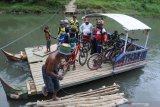Sejumlah pesepeda menggunakan jasa penyeberangan Sungai Bedadung, di Desa Andongsari, Ambulu, Jember, Jawa Timur, Minggu (28/6/2020). Warga memanfaatkan jasa penyeberangan untuk melintasi sungai selebar 50 meter itu dari kawasan kebun dan hutan ke permukiman warga di Kecamatan Ambulu dengan jasa Rp2.000 per orang, akibat putusnya Jembatan (gladak) Korek yang sebelumnya melintang di atas sungai tersebut. Antara Jatim/Seno/zk