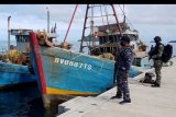 Prajurit TNI AL awak KRI Yos Sudarso-353 berjaga di dekat dua Kapal Ikan Asing (KIA) Vietnam di Pelabuhan Fasilitas Labuh (Faslabuh) TNI AL di Selat Lampa, Natuna, Kepulauan Riau, Sabtu (18/7/2020). KRI Yos Sudarso-353 berhasil menangkap kedua KIA tersebut di perairan Pulau Sekatung dan mengamankan 10 orang WNA beserta barang bukti ikan hasil tangkapannya. ANTARA FOTO/Ardi/nym