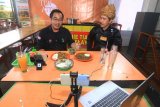 Kepala Kantor Perwakilan Bursa Efek Indonesia (BEI) Kalbar Taufan Febiola (kiri) bersama Koki Bang Yul (kanan) mempromosikan Mie Tiaw Melayu secara live streaming melalui Instagram di Pontianak, Kalimantan Barat, Kamis (23/7/2020). Kegiatan tersebut bertajuk 'Mengunyah Rasa Nusantara, Mencerna Istilah Pasar Modal' dan merupakan program edukasi Waktu Indonesia Berinvestasi (WIB) dari BEI yang bertujuan untuk memperkenalkan kuliner daerah setempat serta memberikan edukasi tentang pasar modal berbasis daring. ANTARA FOTO/Jessica Helena Wuysang