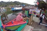 TAMAN BACAAN MASYARAKAT DI TEPI SUNGAI BATANG ARAU PADANG