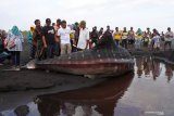 Sejumlah warga melihat seekor Hiu Paus atau Hiu Tutul (Rhincodon typus) yang mati terdampar di Pantai Paseban, Kencong, Jember, Jawa Timur, Minggu (30/8/2020). Seekor Hiu Paus berukuran panjang sembilan meter ditemukan mati terdampar di pantai itu, dan ini menjadi kasus kedua dalam dua bulan terakhir di Kabupaten Jember. Antara Jatim/Seno/zk.