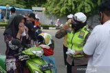 Anggota Polwan polda Aceh membagikan masker keada pengendara sepeda motor di Banda Aceh, Selasa (1/9/2020). Aksi.membagikan sebanya 1.000.masker dalam mendukung progran Gebrakan Memakai MAsker Gratis di aceh dalam mencegah penyebaran covid-19 itu dalam rangka memperingati HUT ke72 Polwan. Antara Aceh/Ampelsa