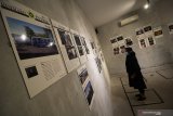 Pengunjung melihat karya foto yang dipajang saat pameran fotografi bertajuk 