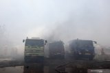 Petugas Dinas Pemadam Kebakaran Kota Surabaya melakukan pembasahan truk tangki yang terbakar di kawasan Dumar Industri, Surabaya, Jawa Timur, Sabtu (12/9/2020). Sekitar 18 kendaraan pemadam kebakaran dikerahkan untuk memadamkan kebakaran diduga berawal dari kebakaran alang-alang yang merembet serta membakar lima truk tangki tersebut. Antara Foto/Didik/Zk