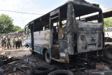 Polisi melakukan identifikasi di lokasi kebakaran garasi bus setelah dilakukan pemadaman di Kota Madiun, Jawa Timur, Selasa (29/9/2020). Garasi bus yang terbakar diduga akibat aktivitas pengelasan bus bekas oleh pekerja tersebut mengakibatkan dua unit bus dan tumpukan ban bekas hangus terbakar. Antara Jatim/Siswowidodo/zk.