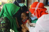 Tenaga kesehatan dari Puskesmas Ketabang memberikan vaksin Measles Rubella (MR) kepada murid SD Negeri Kaliasin V saat pelaksanaan Bulan Imunisasi Anak Sekolah (BIAS) di Surabaya, Jawa Timur, Kamis (15/10/2020). Pemerintah Kota Surabaya menggelar Bulan Imunisasi Anak Sekolah (BIAS) dengan program imunisasi Measles Rubella (MR) dan Human Papiloma Virus (HPV) guna menjaga sistem kekebalan tubuh dari penyakit campak dan penyakit rahim. Antara Jatim/Moch Asim/zk.
