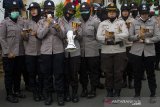 Anggota Polisi Wanita membacakan Asmaul Husna saat aksi unjuk rasa menolak Undang-Undang Cipta Kerja di Gedung DPRD Kabupaten Karawang, Karawang, Jawa Barat, Selasa (20/10/2020). Kegiatan tersebut untuk meredam emosi demonstran agar tidak terprovokasi dan bertindak anarkis dalam aksi tersebut. ANTARA JABAR/M Ibnu Chazar/agr