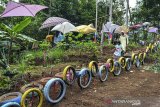 Pengunjung menikmati wahana permainan di Wisata Bukit Sinarmulya Bojongsari, Desa Gegempalan, Kabupaten Ciamis, Jawa Barat, Sabtu (31/10/2020). Pemerintah Desa setempat mengembangkan wisata edukasi dan religi dengan menyediakan wahana permainan tradisional berupa ayunan, perosotan, jungkitan, roller coaster dari bambu atau lori-lorian serta engrang. ANTARA JABAR/Adeng Bustomi/agr