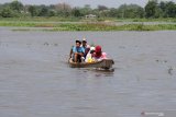 Warga menggunakan perahu di desa Kedungringin, Beji, Pasuruan, Jawa Timur, Rabu (4/11/2020). Warga setempat menggunakan perahu untuk beraktivitas di luar rumah akibat banjir yang merendam ratusan rumah selama lima hari dengan ketinggian mencapai satu meter. Antara Jatim/Umarul Faruq/zk