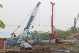 Pekerja menggunakan alat berat menyelesaikan pembangunan jalan akses Tol Cipali menuju Bandara BIJB di Kertajati, Majalengka, Jawa Barat, Minggu (8/11/2020). Pembangunan ruas tol akses Cipali menuju Bandara Kertajati sepanjang 3,70 kilometer itu ditargetkan rampung pada 2021 mendatang dan diharapkan mampu mendukung konektivitas menuju ke Bandara Kertajati sehingga berkontribusi mengembangkan kawasan di sekitarnya. ANTARA JABAR/Dedhez Anggara/agr