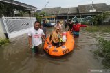Warga berupaya keluar dari kawasan banjir di Desa Kwadungan, Kediri, Jawa Timur, Kamis (7/1/2021). Ratusan rumah di wilayah itu terendam banjir usai hujan deras dan meluapnya sungai yang membawa air dari daerah yang lebih tinggi. Antara Jatim/Prasetia Fauzani/ZK