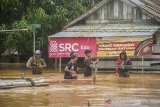 Sejumlah warga melintasi banjir di Desa Pekauman Ulu, Kabupaten Banjar, Kalimantan Selatan, Minggu (17/1/2021). Pusat Data Informasi dan Komunikasi Kebencanaan Badan Nasional Penanggulangan Bencana melaporkan sebanyak 10 Kabupaten/Kota terdampak banjir di Provinsi Kalimantan Selatan, antara lain Kabupaten Tapin, Kabupaten Banjar, Kota Banjar Baru, Kota Tanah Laut, Kota Banjarmasin, Kabupaten Hulu Sungai Tengah, Kabupaten Balangan, Kabupaten Tabalong, Kabupataen Hulu Sungai Selatan, dan Kabupaten Batola. Foto Antaranews Kalsel/Bayu Pratama S.