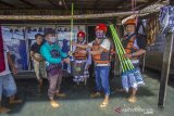 Wakil Ketua Federasi Arung Jeram Indonesia (FAJI) Kalsel Bandi Chairulah (dua kanan) menyerahkan bantuan cleaning kit kepada warga yang terdampak banjir di Desa Keliling Benteng Ulu, Kabupaten Banjar, Kalimantan Selatan, Jumat (12/1/2021). Satgas banjir FAJI Kalsel menyalurkan bantuan 100 cleaning kit dari Global Rescue Network (GRN) kepada warga korban banjir di Kabupaten Banjar. Foto Antaranews Kalsel/Bayu Pratama S.