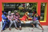 Pelatih anjing, Aril Saputra memakaikan masker kepada anjingnya bernama Joy di Alun-alun Kota Tasikmalaya, Jawa Barat, Senin (15/2/2021). Anjing berjenis Golden Retriever ini sengaja dilatih untuk mengedukasi masyarakat dalam mematuhi protokol kesehatan saat pandemi COVID-19 dan tertib berlalu-lintas. ANTARA JABAR/Adeng Bustomi/agr