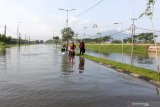 Pengendara menerobos banjir yang menggenangi jalan raya Porong, Sidoarjo, Jawa Timur, Selasa (16/2/2021). Curah hujan yang tinggi sejak Senin (15/2) malam mengakibatkan banjir yang merendam jalan raya Porong sehingga mengganggu kelancaran transportasi umum. Antara Jatim/Umarul Faruq/zk