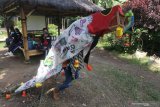 Dua orang anak memainkan barongsai yang terbuat dari barang bekas dan sampah plastik di Kampung Dongeng Ramadhani, Kelurahan Mojoroto, Kota Kediri, Jawa Timur, Minggu (21/2/2021). Pentas tari bertajuk 'Barongsai Sampah' tersebut guna memperingati Hari Peduli Sampah Nasional. Antara Jatim/Prasetia Fauzani/zk