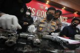 Polisi menunjukkan barang bukti saat ungkap kasus kepemilikan senjata api ilegal di Polda Jawa Timur, Surabaya, Jawa Timur, Selasa (16/3/2021). Polda Jawa Timur menangkap KD (33) dan UC (46) atas kasus dugaan mengedarkan narkoba sekaligus memiliki senjata api ilegal serta mengamankan sejumlah barang bukti diantaranya dua pucuk senjata api rakitan jenis revolver, satu pucuk air soft gun jenis FN dan 20 butir amunisi kaliber 38 mm. Antara Jatim/Didik Suhartono/zk