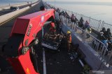 Petugas Rescue dari Dinas Pemadam Kebakaran Kota Surabaya mengevakuasi mobil yang mengalami kecelakaan di Jembatan Suramadu, Surabaya, Jawa Timur, Jumat (19/3/2021). Kecelakan mobil 'pick-up' bernopol L 8094 PF yang diduga menabrak pemisah jalan jembatan tersebut mengakibatkan satu penumpang meninggal dunia dan pengemudinya luka. Antara Jatim/Didik Suhartono/zk