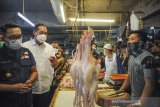 Menteri Perdagangan Muhammad Lutfi (kedua kiri) bersama Gubernur Jawa Barat Ridwan Kamil (kiri) berbincang dengan pedagang ayam saat melakukan kunjungan kerja di Pasar Kosambi, Bandung, Jawa Barat, Selasa (13/4/2021). Dalam kunjungan kerjanya di Bandung, Menteri Perdagangan berkesempatan memantau harga kebutuhan pokok pada hari pertama puasa di Pasar Kosambi dan Pasar Sederhana. ANTARA JABAR/Raisan Al Farisi/agr