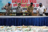 Polisi melemparkan minuman keras untuk dimusnahkan di Polrestabes Surabaya, Jawa Timur, Selasa (13/4/2021). Polrestabes Surabaya memusnahkan barang bukti minuman keras berbagai merk dan kemasan sebanyak 4.696 botol yang disita dalam Operasi Pekat Semeru periode 22 Maret sampai 2 April 2021. Antara Jatim/Didik Suhartono/zk.