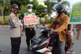 Petugas menegur pengendara saat operasi yustisi penegakan hukum protokol kesehaan pencegahan penularan COVID-19 di kawasan Alun-alun Kota Madiun, Jawa Timur, Selasa (13/4/2021). Operasi yang dilakukan petugas gabungan Polisi, Satpol PP dan petugas Badan Penanggulangan Bencana Daerah (BPBD) menyasar pada para pengendara yang tak menggunakan masker atau menggunakan masker namun tidak menutup seluruh hidung dan mulut guna pencegahan penularan COVID-19. Antara Jatim/Siswowidodo/zk.